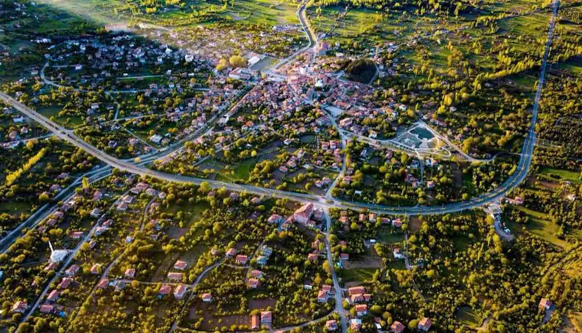 Eldivan ilçe merkezinin havadan görünümü: kırmızı çatılı evler, yeşil alanlar ve ilçeyi saran yol
